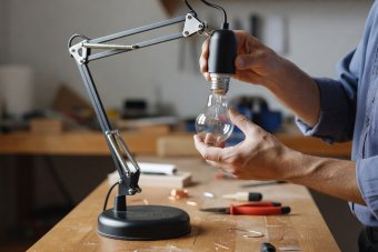 Close-up comparison of an E27 Edison screw base and a compact GU10 spotlight